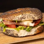 Thinly sliced Prosciutto di Parma with peppery rocket, ripe tomato, basil, red onion, and mozzarella, dressed with aioli for an Italian-inspired treat